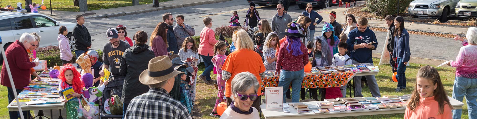 a crowd of people looking over tables of free children's books