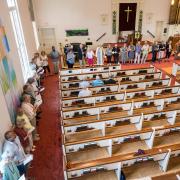 Congregants line the perimeter of the sanctuary for the closing hymn, "We Are Dancing Sarah's Circle"