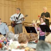 Thom Whittemore with East Church backup, leads workshop participants